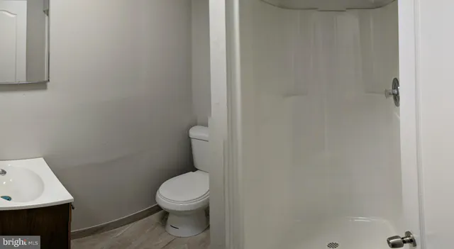 a bathroom with a toilet a sink and a window
