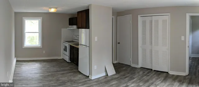 a utility room with wooden floor washer and dryer