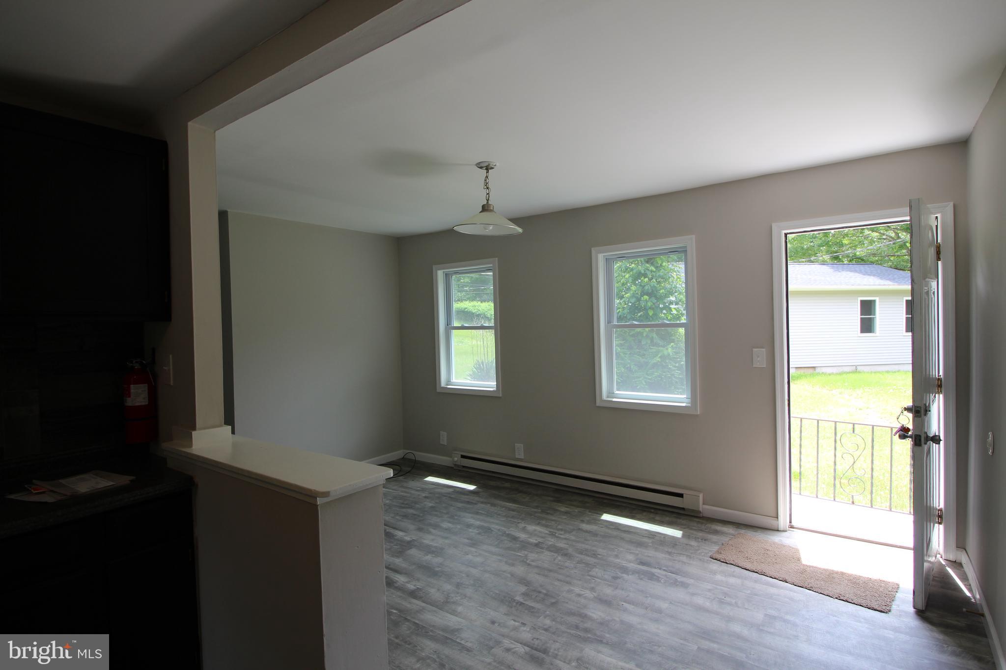 424 Trenton Road Browns Mills, NJ 08015 - Photo 22 of 109 a view of an empty room with wooden floor and a window