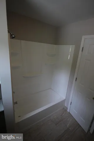 a bathroom with a granite countertop toilet and a sink