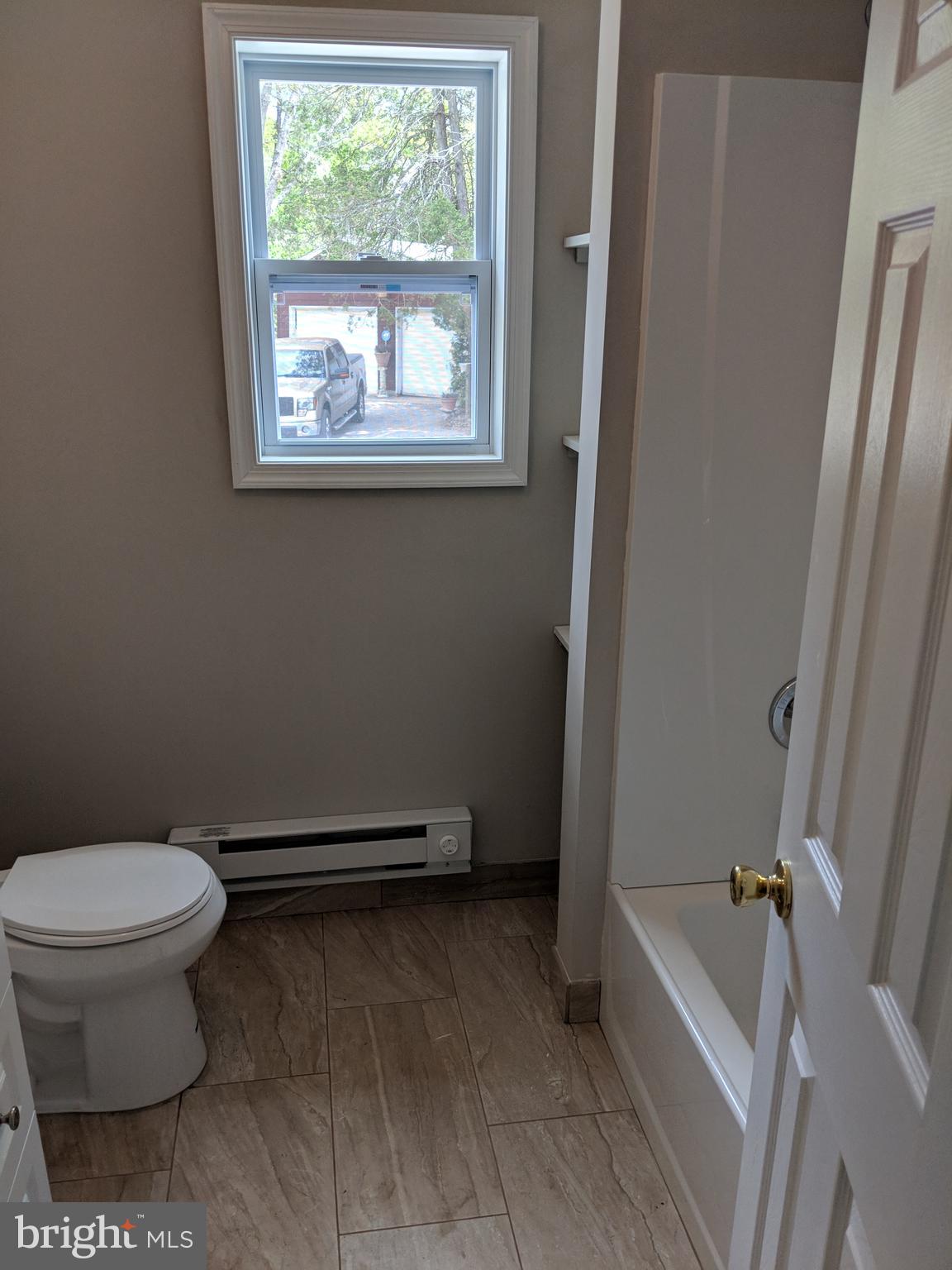 424 Trenton Road Browns Mills, NJ 08015 - Photo 31 of 109 a bathroom with a toilet and a bath tub