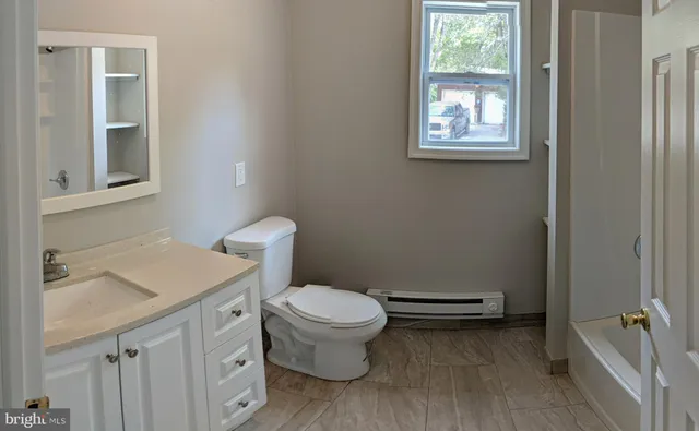 a view of a room with wooden floor and bathroom