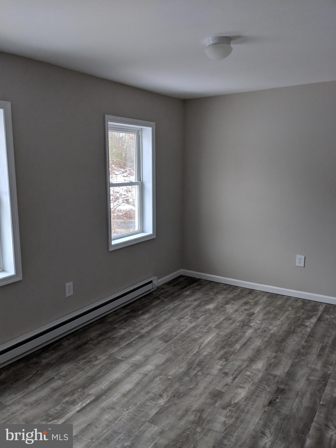 424 Trenton Road Browns Mills, NJ 08015 - Photo 41 of 109 a view of an empty room with wooden floor and a window