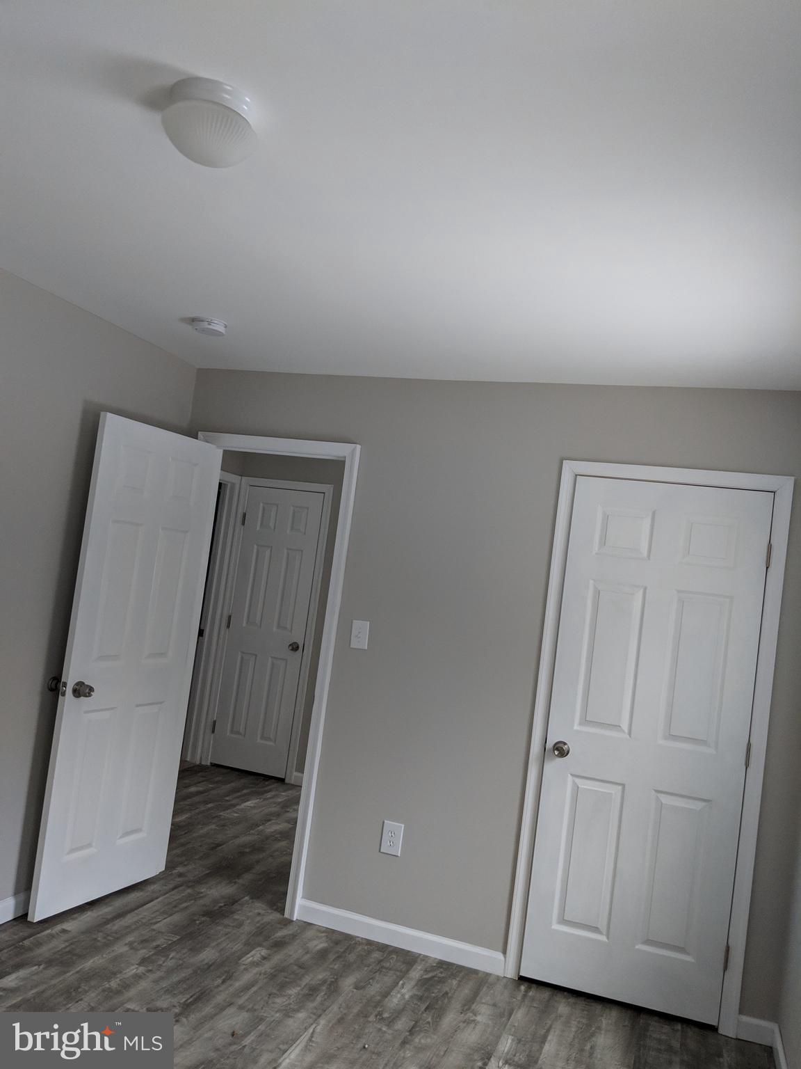 424 Trenton Road Browns Mills, NJ 08015 - Photo 43 of 109 an empty room with wooden floor and a hallway
