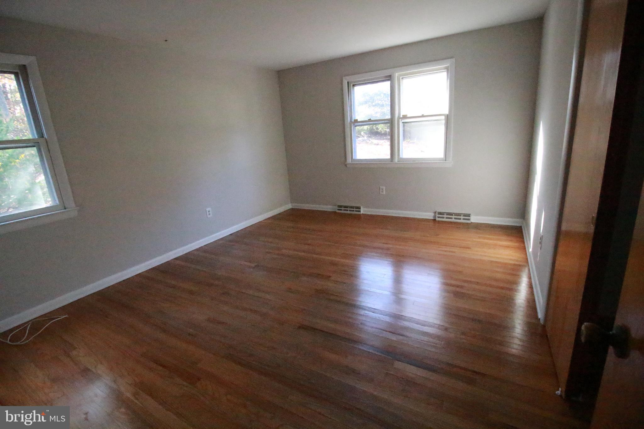424 Trenton Road Browns Mills, NJ 08015 - Photo 66 of 109 an empty room with wooden floor and windows