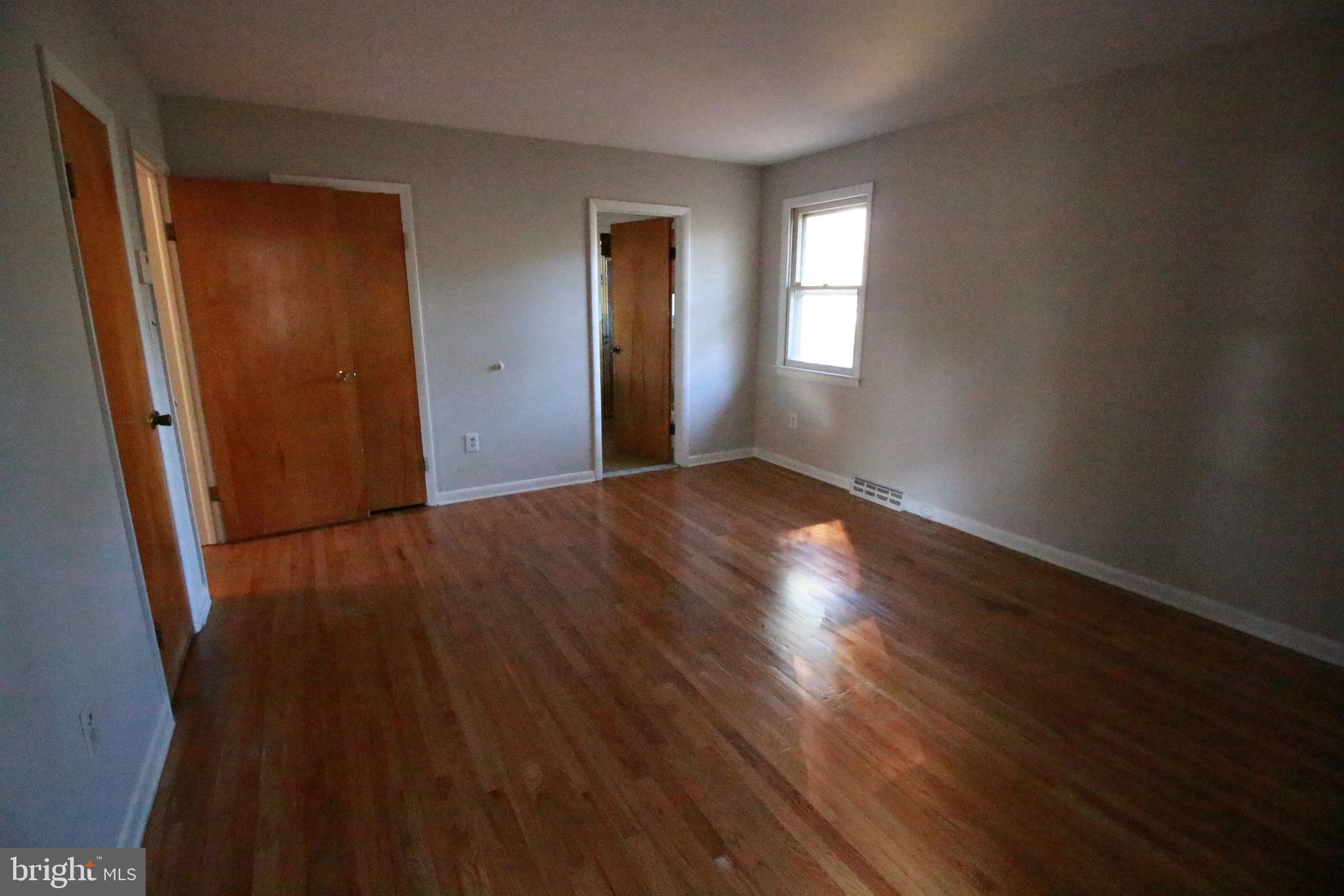 424 Trenton Road Browns Mills, NJ 08015 - Photo 72 of 109 a view of an empty room with wooden floor and a window