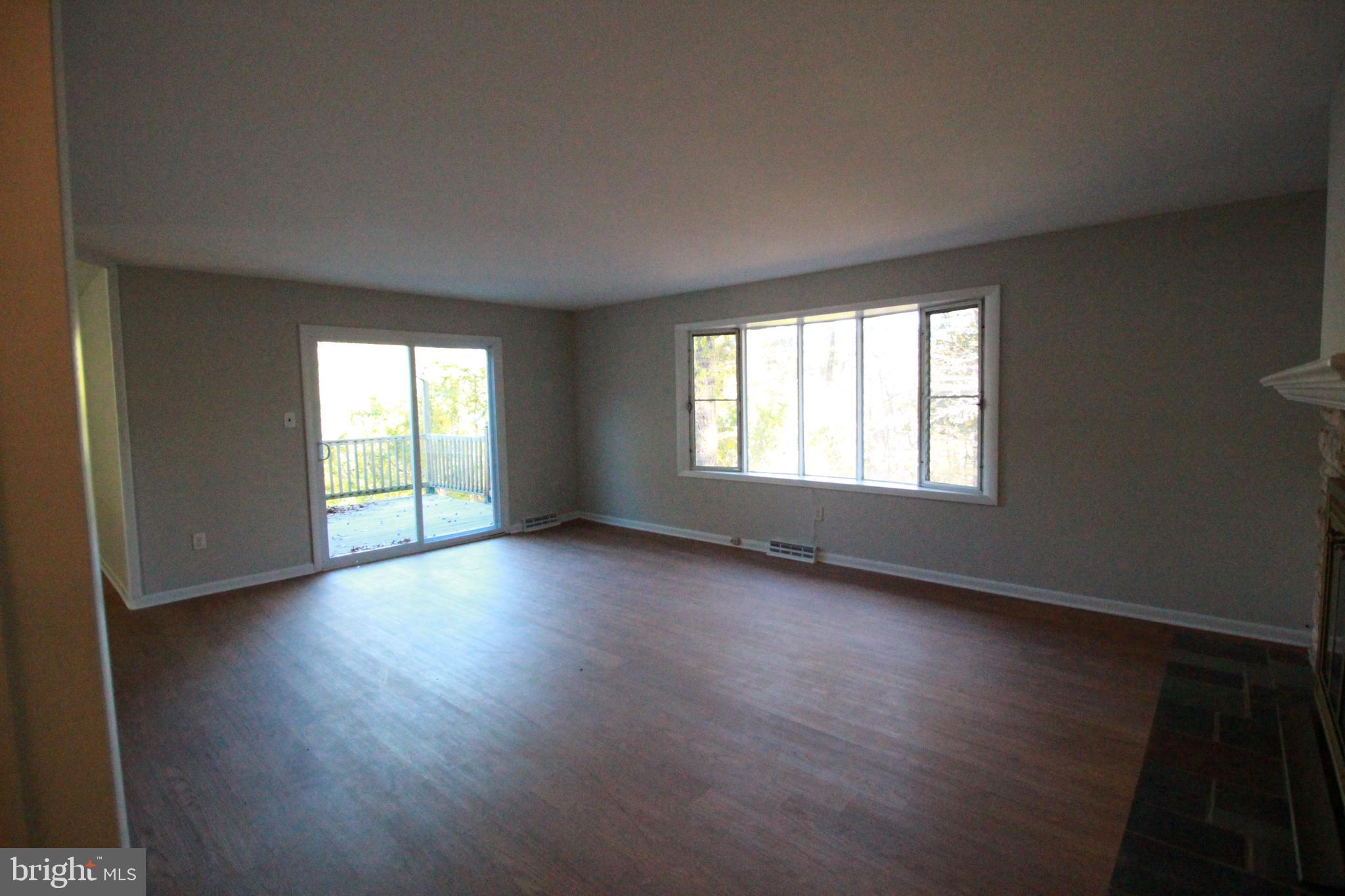 424 Trenton Road Browns Mills, NJ 08015 - Photo 78 of 109 a view of an empty room with wooden floor and a window