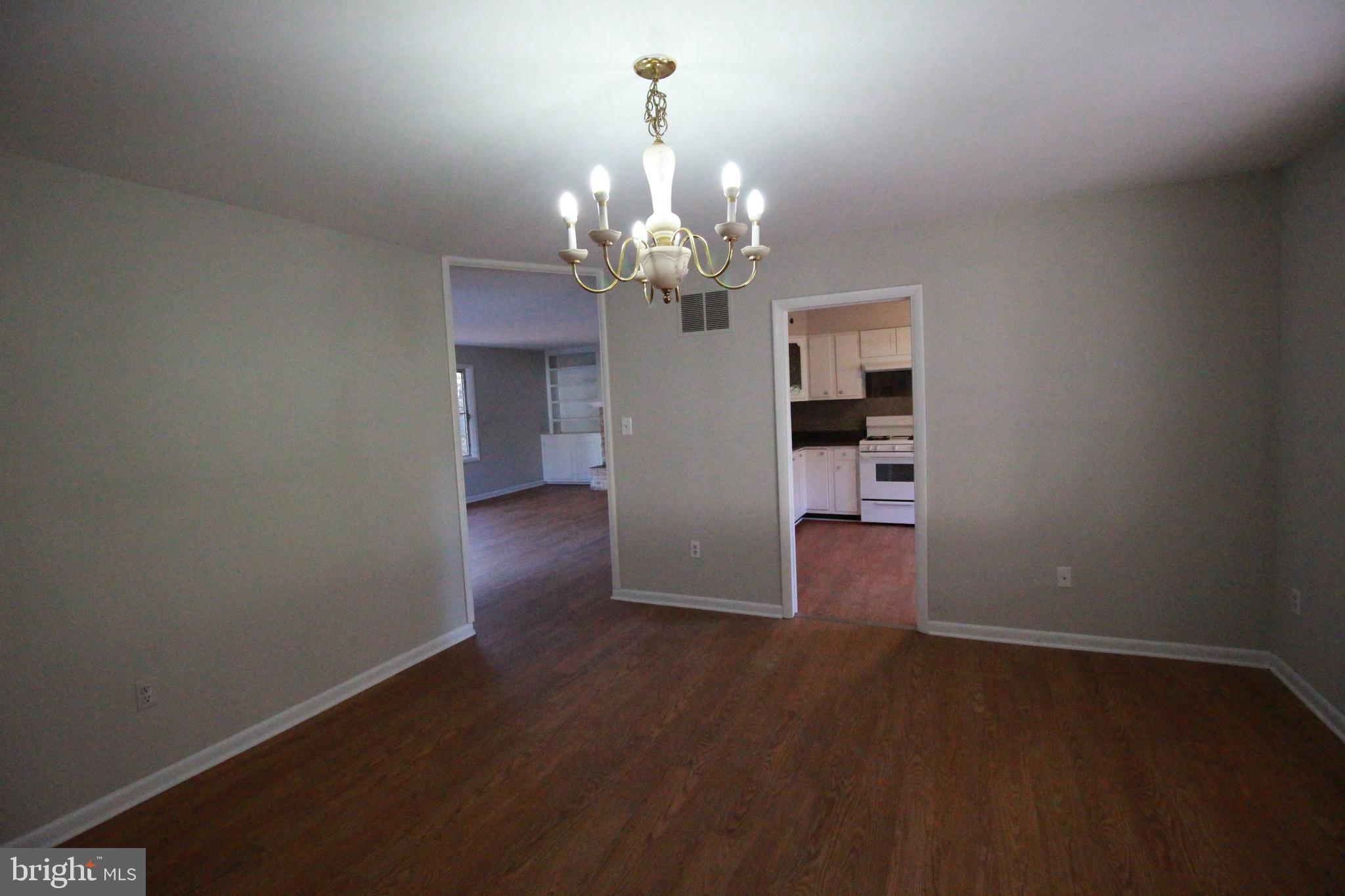 424 Trenton Road Browns Mills, NJ 08015 - Photo 82 of 109 a view of a big room with wooden floor a chandelier and entryway