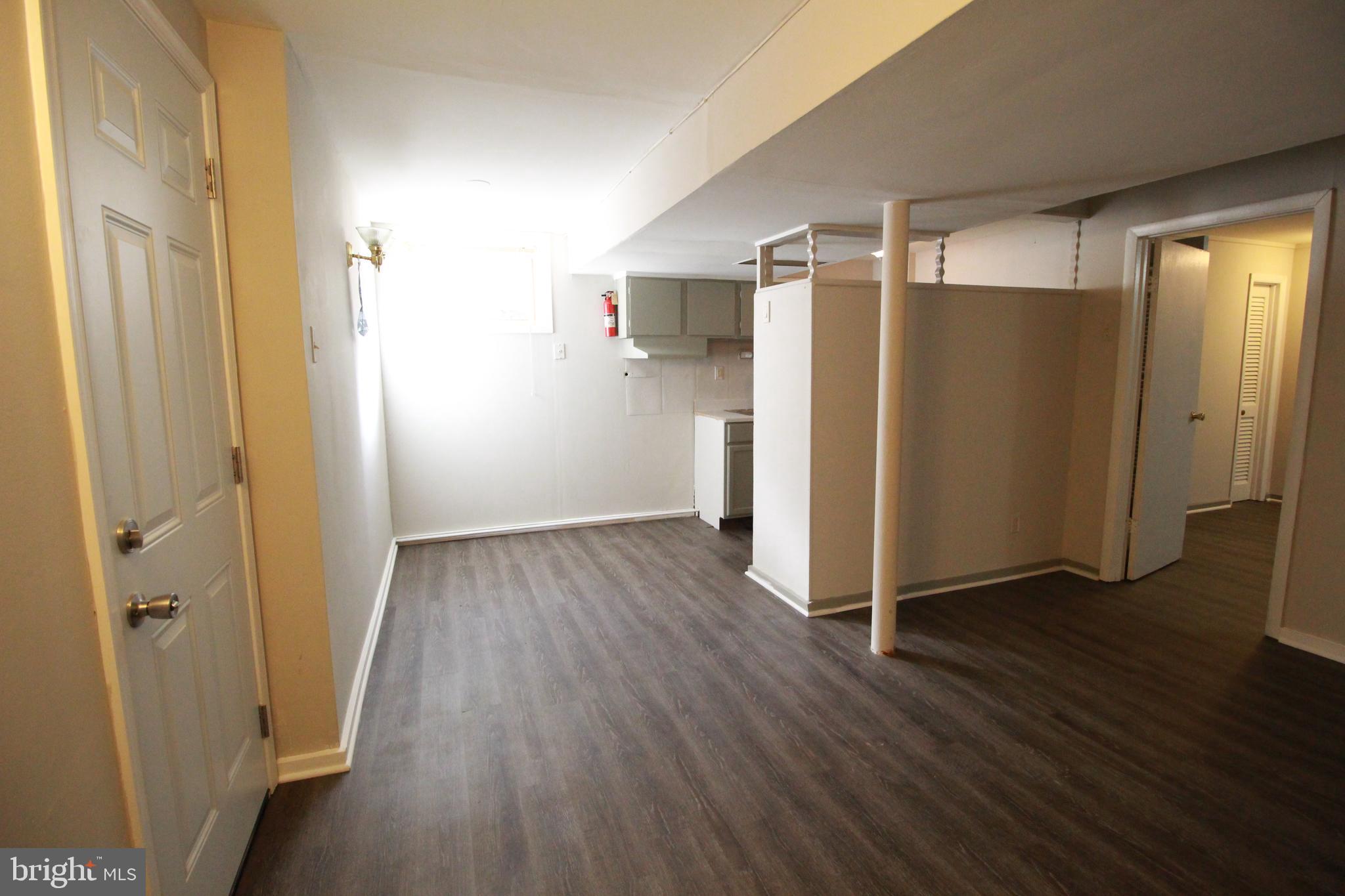 424 Trenton Road Browns Mills, NJ 08015 - Photo 89 of 109 a view of a hallway with wooden floor and a refrigerator