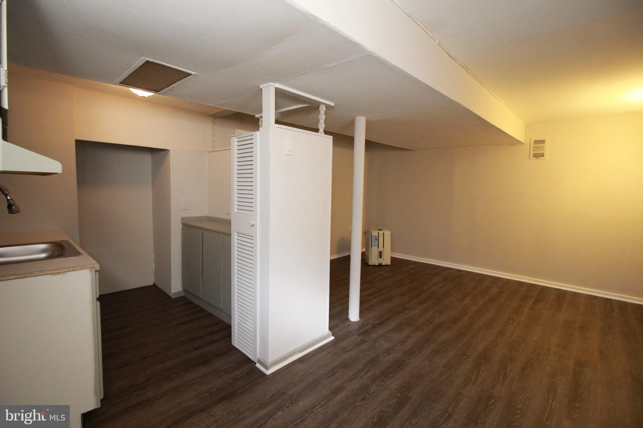 424 Trenton Road Browns Mills, NJ 08015 - Photo 90 of 109 a view of an empty room with wooden floor and a sink