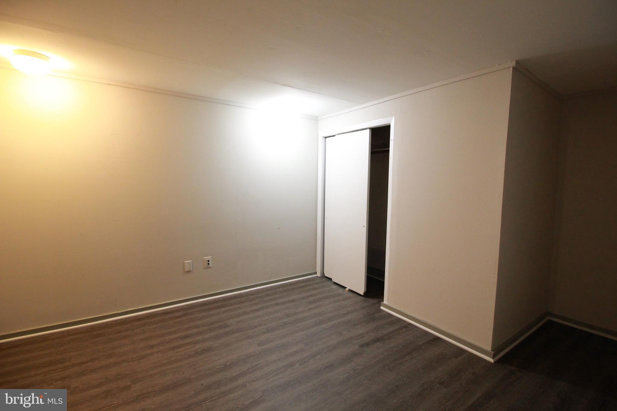 424 Trenton Road Browns Mills, NJ 08015 - Photo 93 of 109 an empty room with wooden floor and white walls