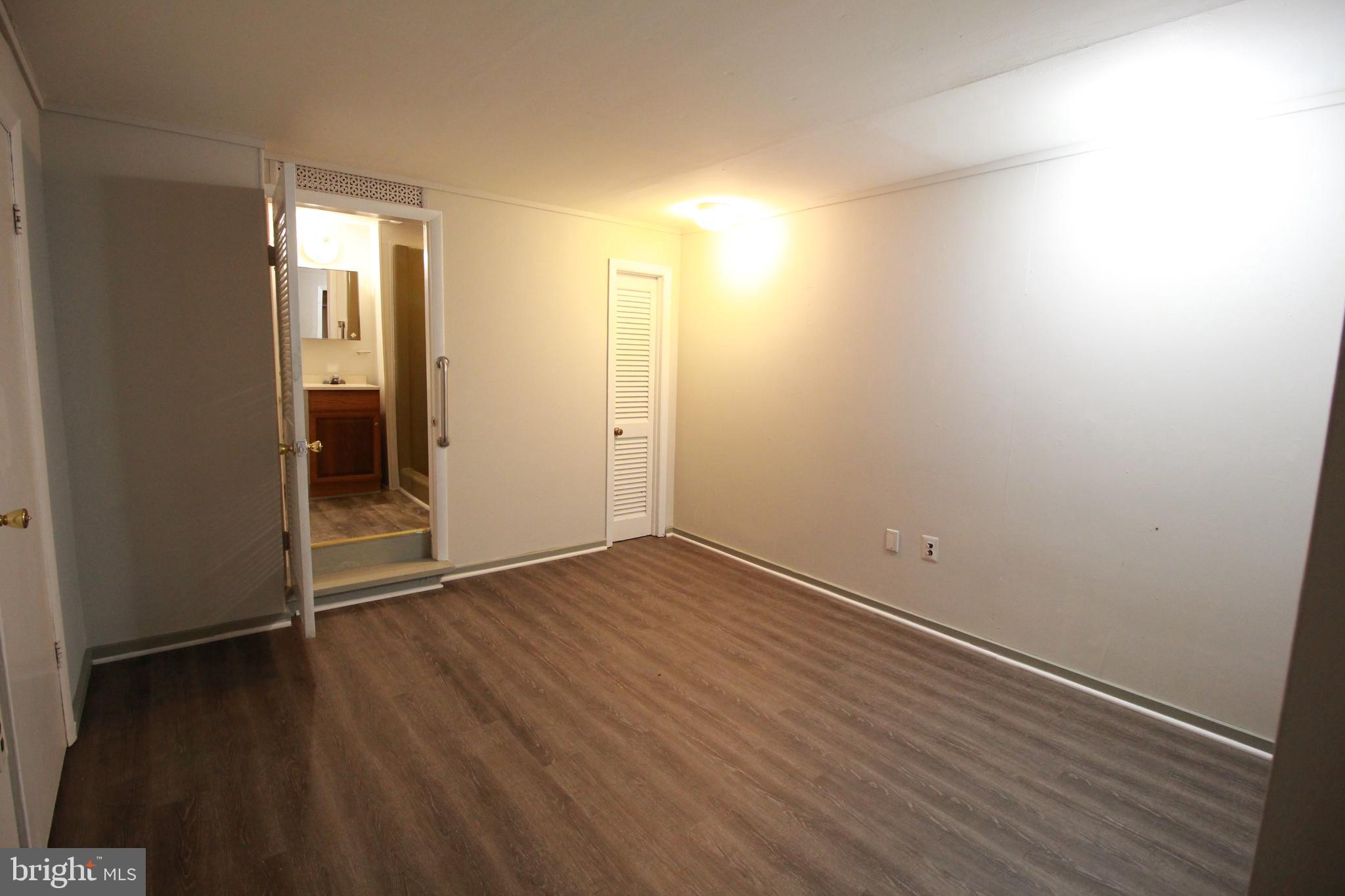 424 Trenton Road Browns Mills, NJ 08015 - Photo 94 of 109 an empty room with wooden floor and windows