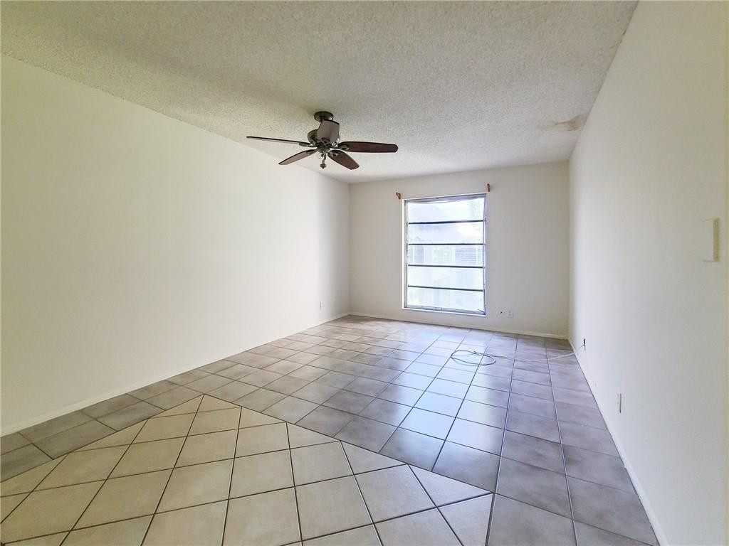 8301 Sands Point Boulevard, Unit 306S Tamarac, FL 33321 - Photo 6 of 13 a view of an empty room and window