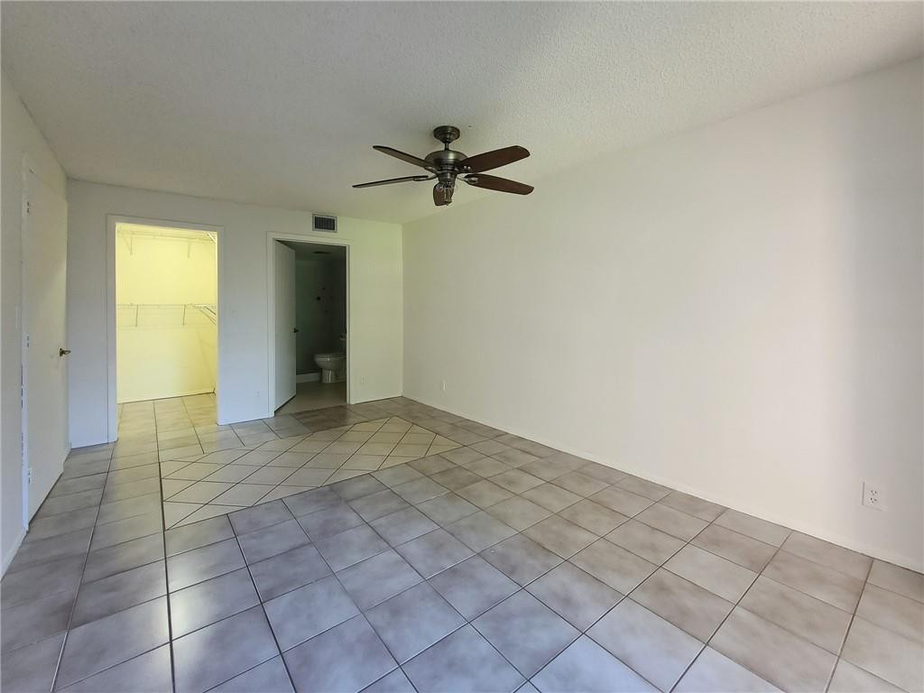 8301 Sands Point Boulevard, Unit 306S Tamarac, FL 33321 - Photo 7 of 13 an empty room with closet and windows