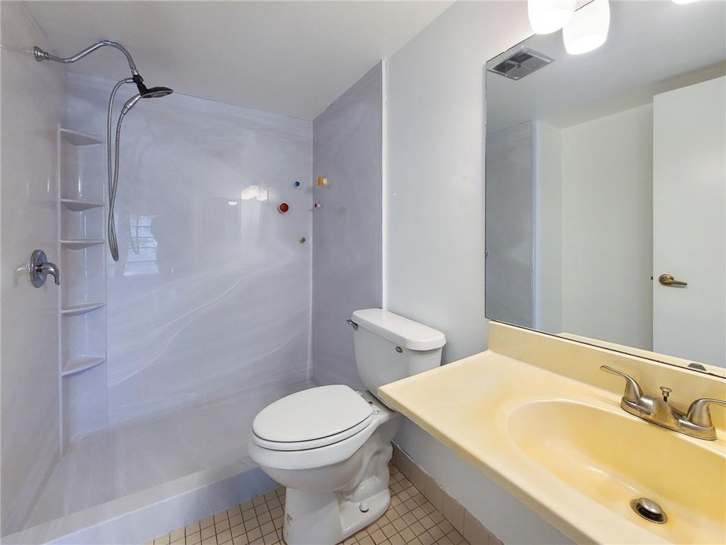 8301 Sands Point Boulevard, Unit 306S Tamarac, FL 33321 - Photo 8 of 13 a bathroom with a sink a toilet and shower