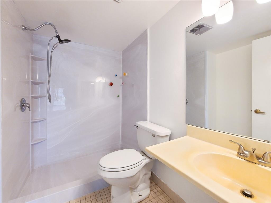 8301 Sands Point Boulevard, Unit 306S Tamarac, FL 33321 - Photo 9 of 13 a bathroom with a sink a toilet and shower