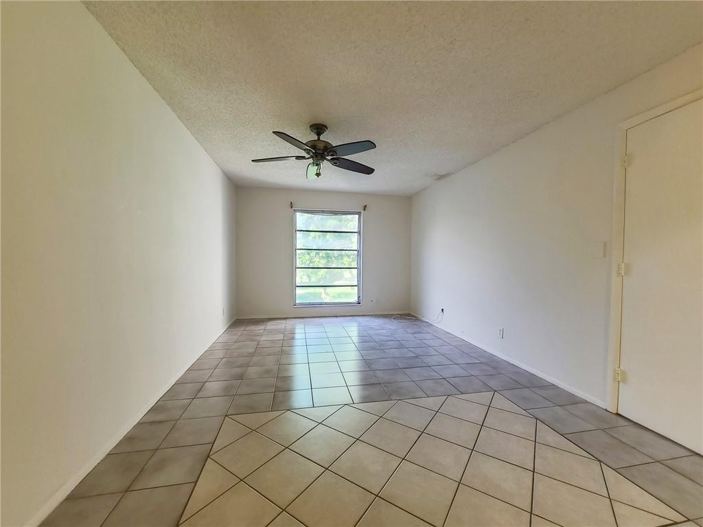 8301 Sands Point Boulevard, Unit 306S Tamarac, FL 33321 - Photo 10 of 13 a view of an empty room with a window