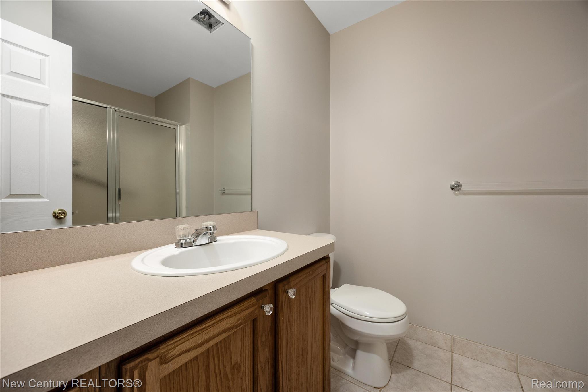 26013 Ranger Avenue Warren, MI 48091 - Photo 12 of 25 Bathroom featuring a shower stall, vanity, and light tile patterned flooring