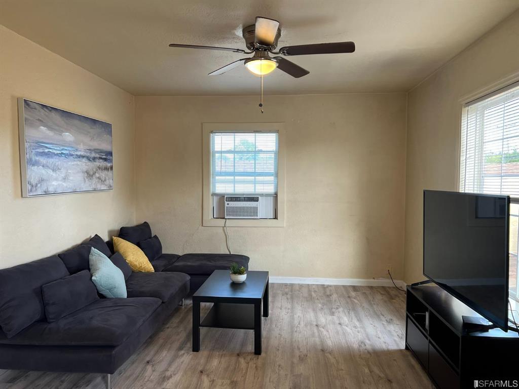 940 Mariposa Street Rodeo, CA 94572 - Photo 3 of 21 a living room with furniture and a flat screen tv