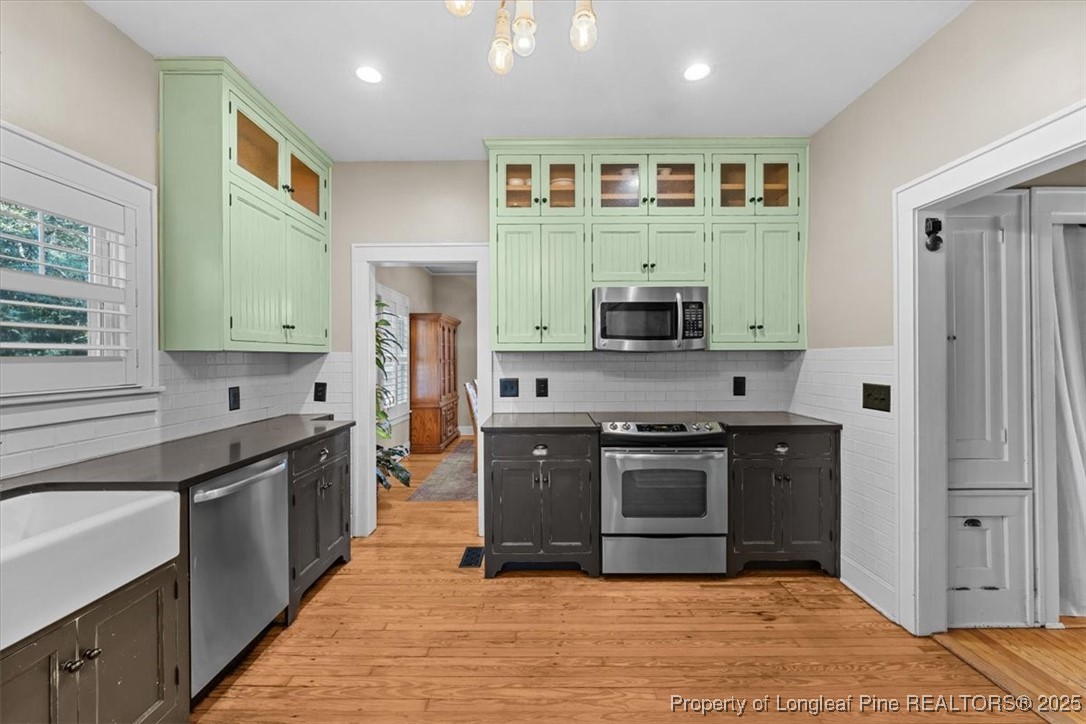 440 Kensington Road Southern Pines, NC 28387 - Photo 21 of 50 a kitchen with stainless steel appliances granite countertop a stove and a sink