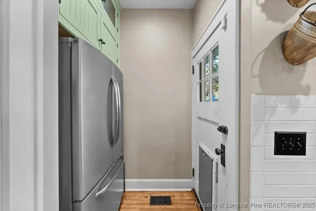 a dining room with furniture a chandelier and wooden floor