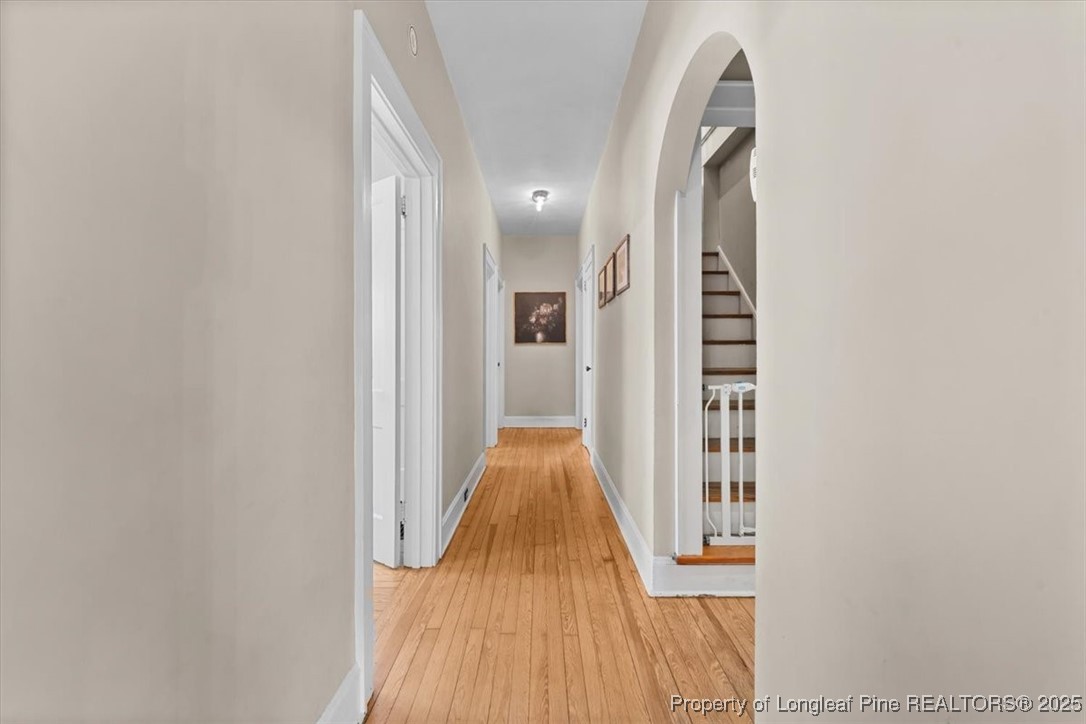 440 Kensington Road Southern Pines, NC 28387 - Photo 26 of 50 a view of a hallway with wooden floor and staircase