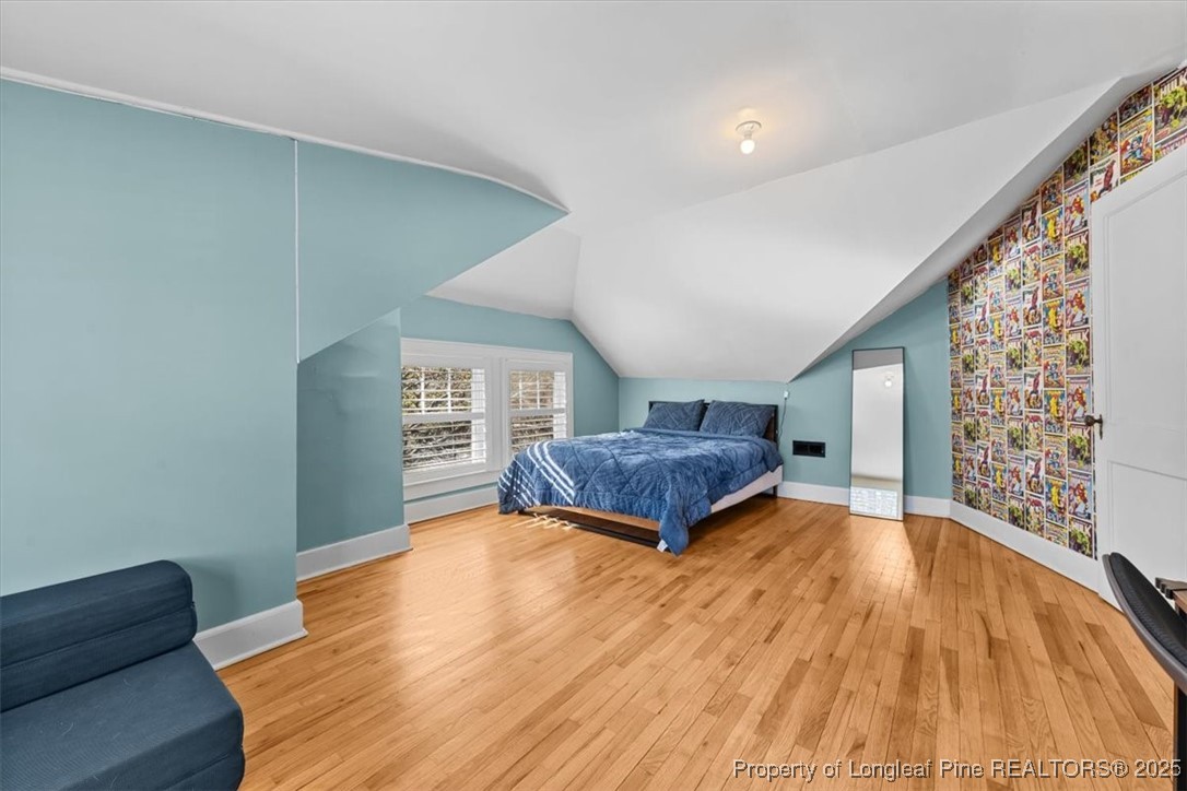 440 Kensington Road Southern Pines, NC 28387 - Photo 30 of 50 a bedroom with a bed and wooden floor