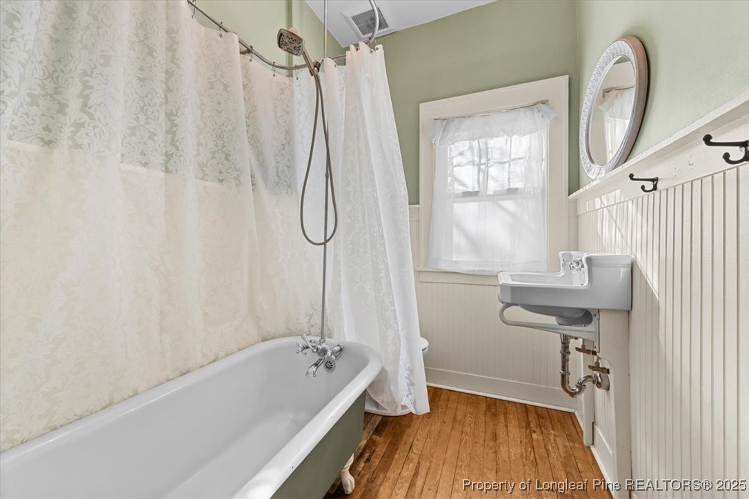 440 Kensington Road Southern Pines, NC 28387 - Photo 35 of 50 a bathroom with a sink a mirror and a bathtub