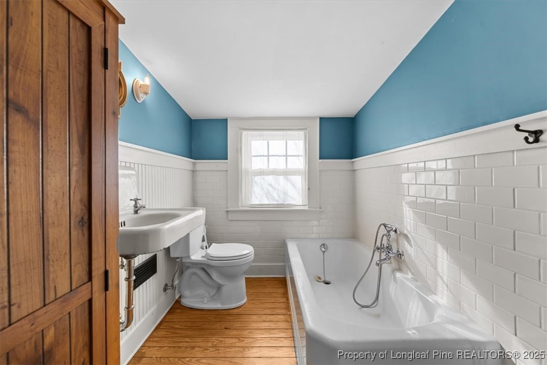 440 Kensington Road Southern Pines, NC 28387 - Photo 37 of 50 a bathroom with a sink a toilet and bathtub