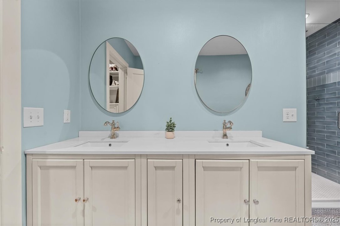 440 Kensington Road Southern Pines, NC 28387 - Photo 43 of 50 a bathroom with 2 sink and a mirror