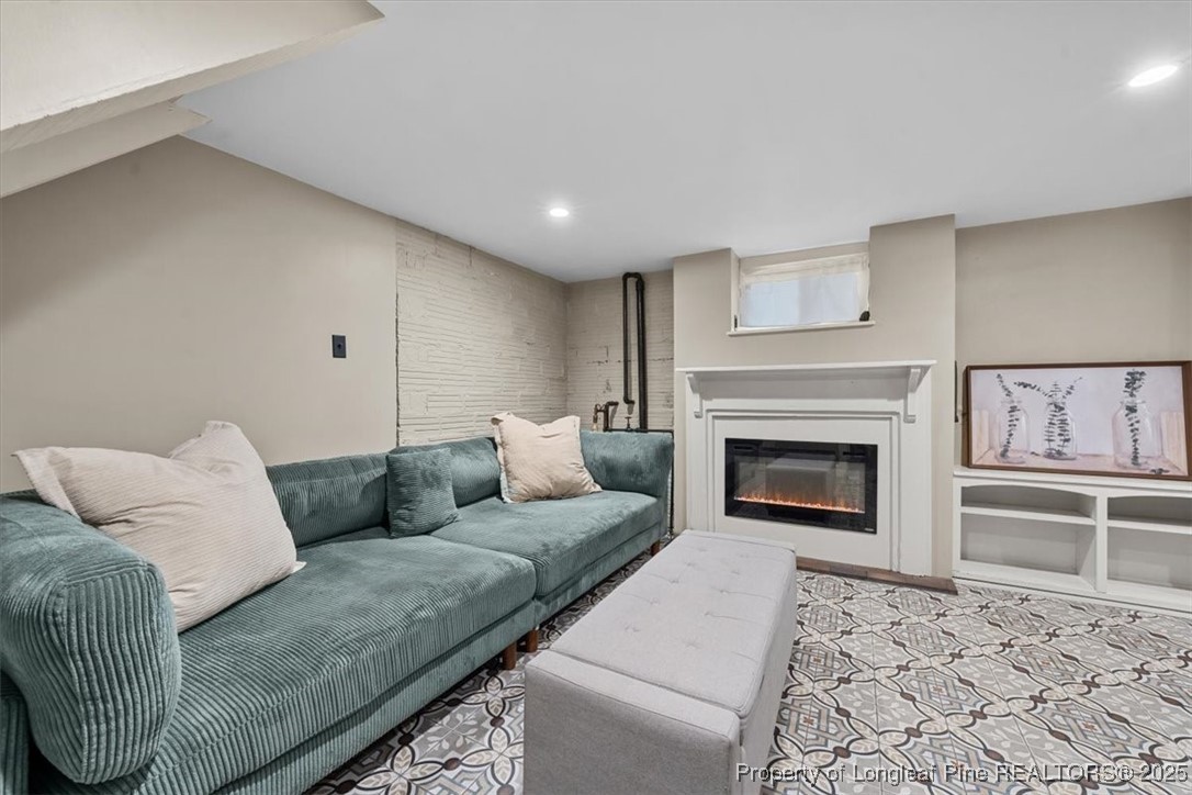 440 Kensington Road Southern Pines, NC 28387 - Photo 45 of 50 a living room with furniture and a fireplace