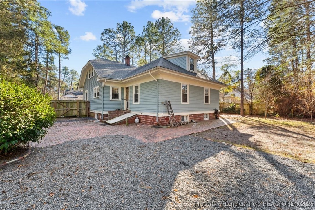 440 Kensington Road Southern Pines, NC 28387 - Photo 5 of 50 a view of a house with a yard and a tree