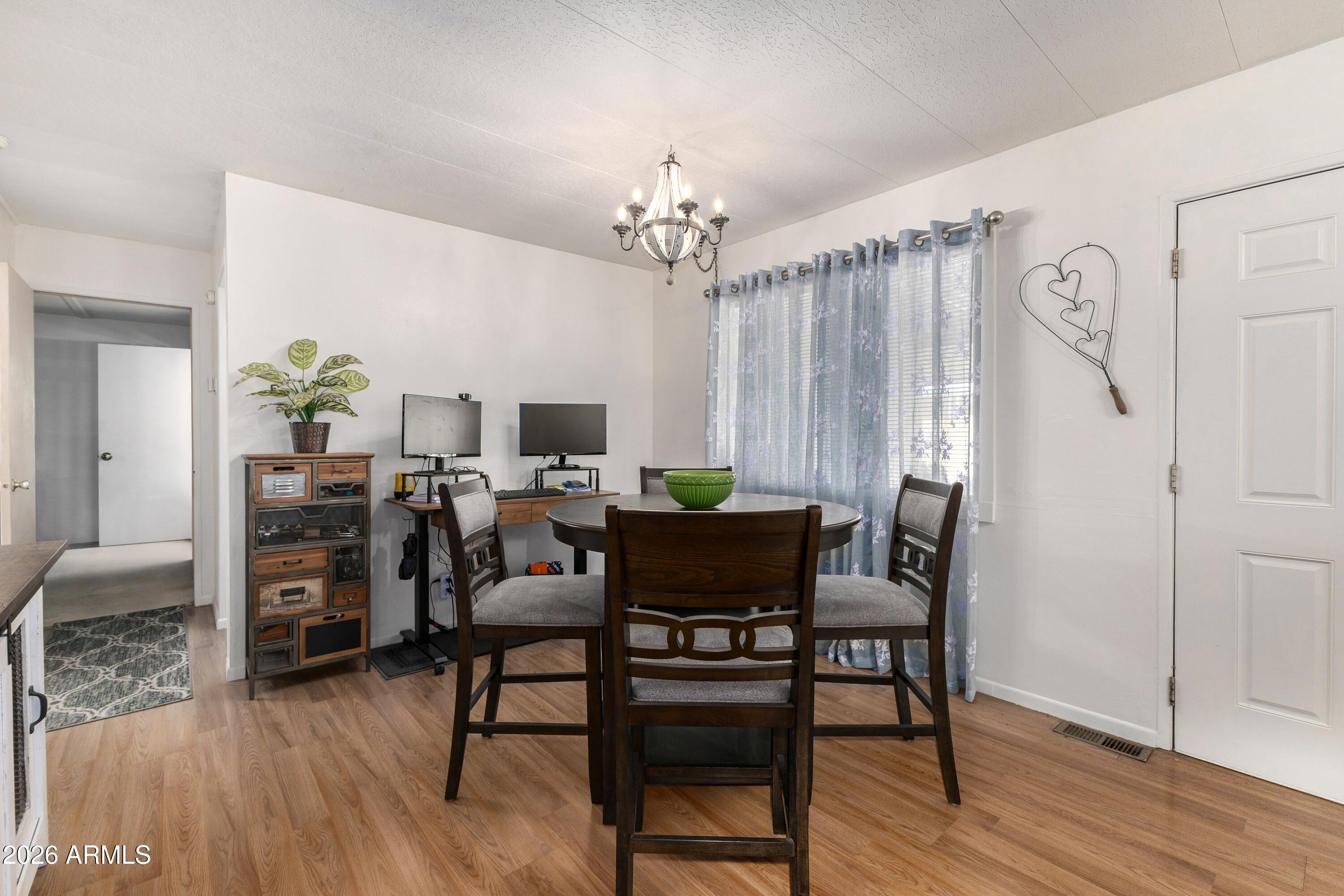 758 South 87th Way Mesa, AZ 85208 - Photo 13 of 24 a view of a dining room with furniture and wooden floor