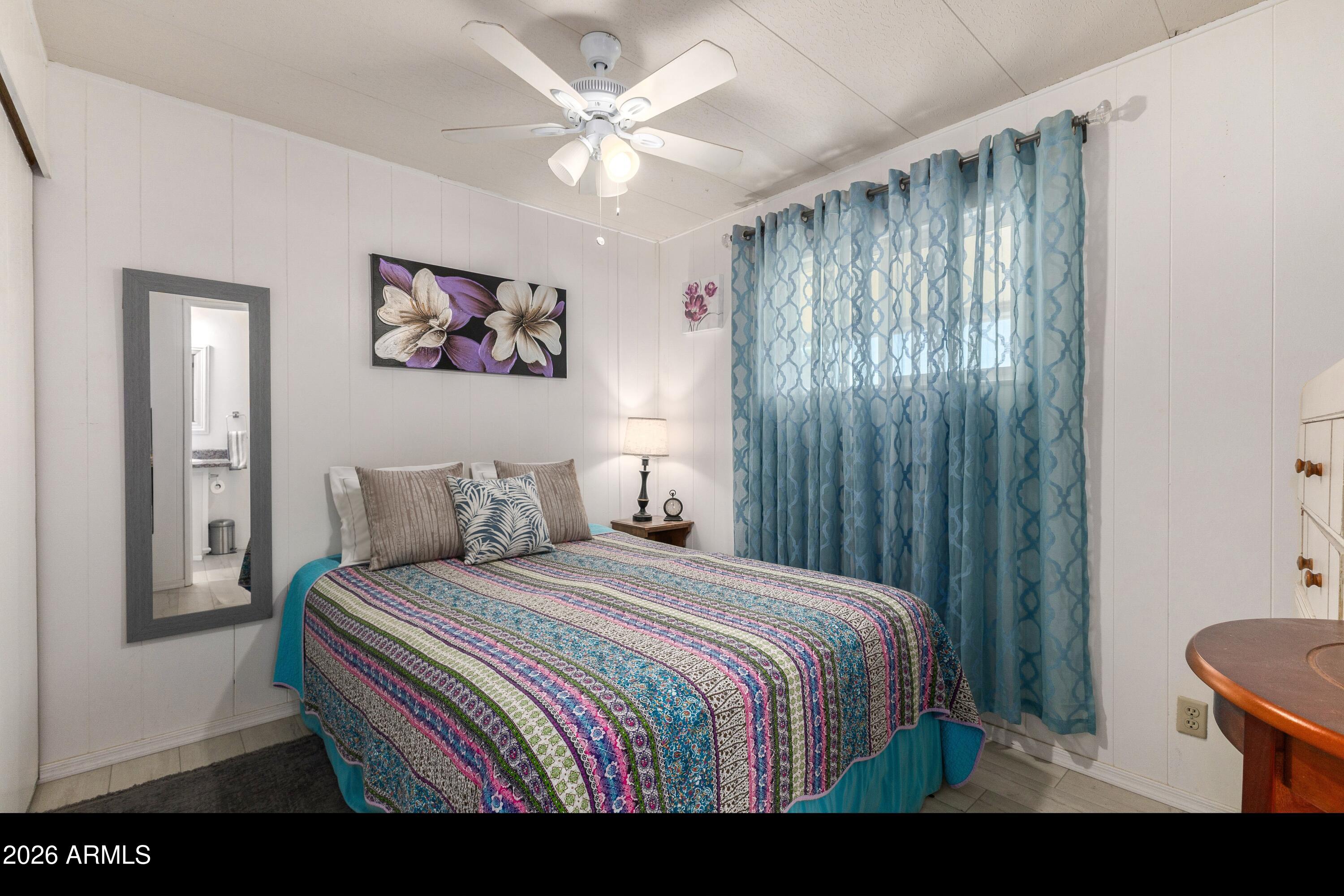 758 South 87th Way Mesa, AZ 85208 - Photo 14 of 24 a bedroom with a bed and a chandelier