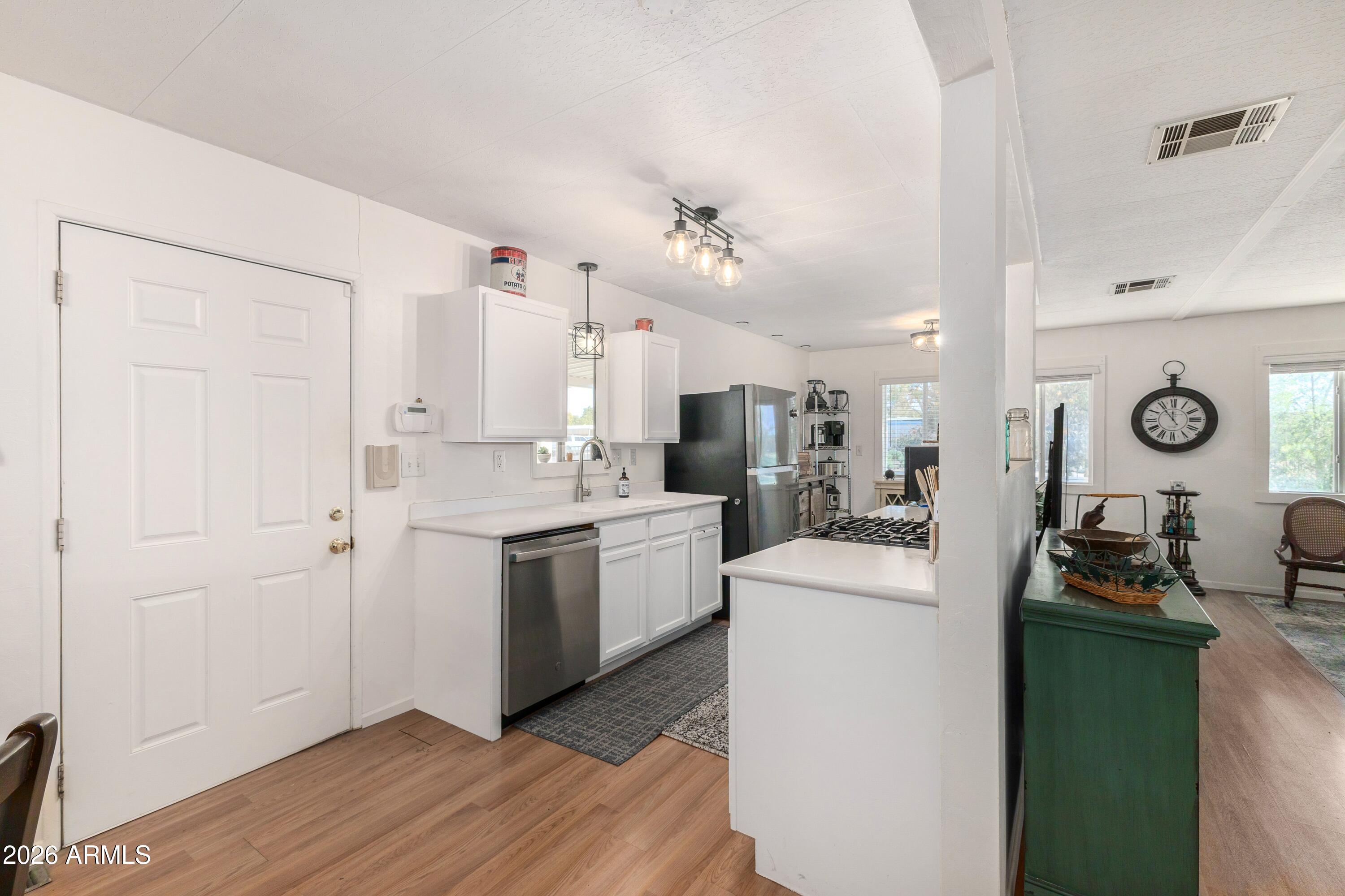 758 South 87th Way Mesa, AZ 85208 - Photo 5 of 24 a kitchen with refrigerator and cabinets