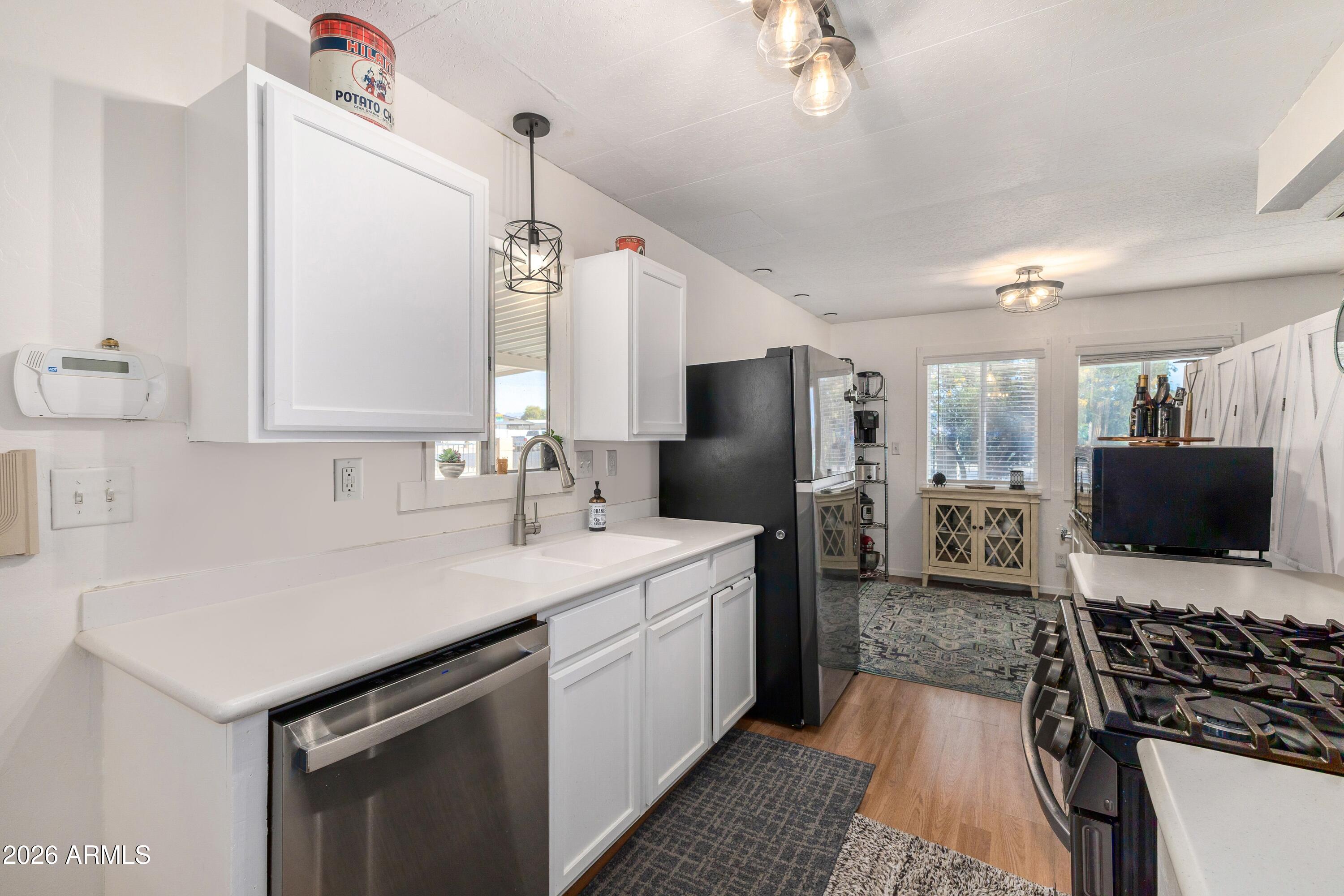 758 South 87th Way Mesa, AZ 85208 - Photo 9 of 24 a kitchen with a sink stove and refrigerator
