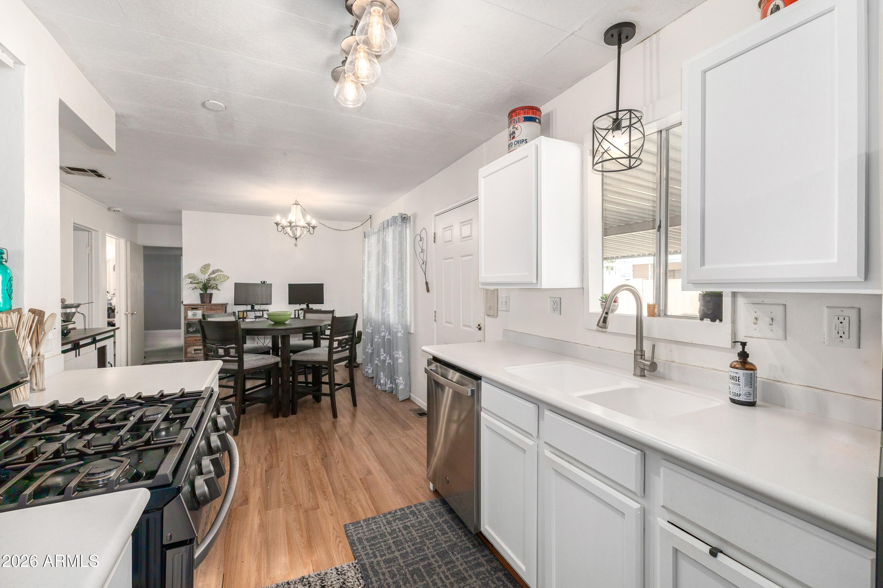 758 South 87th Way Mesa, AZ 85208 - Photo 10 of 24 a kitchen with sink cabinets and window