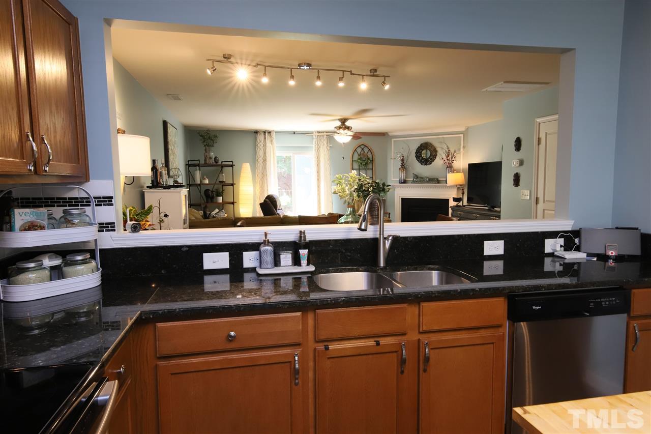 2917 Berkeley Springs Place Raleigh, NC 27616 - Photo 7 of 30 a kitchen with granite countertop a sink and cabinets