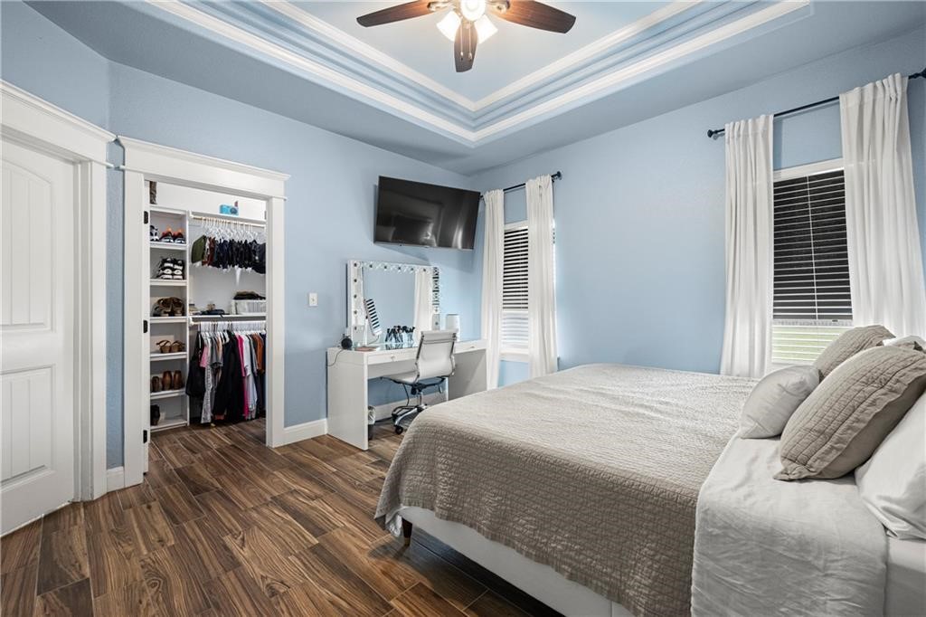 1570 Maryville Loop Beeville, TX 78102 - Photo 12 of 19 a bedroom with a bed and a chandelier