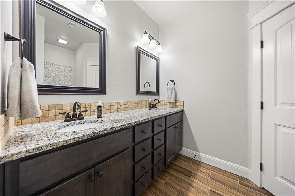 1570 Maryville Loop Beeville, TX 78102 - Photo 16 of 19 a bathroom with double vanity and a mirror