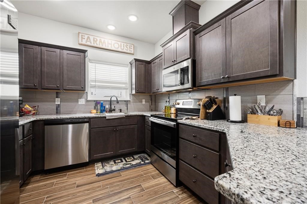 1570 Maryville Loop Beeville, TX 78102 - Photo 8 of 19 a kitchen with stainless steel appliances granite countertop a sink stove and cabinets