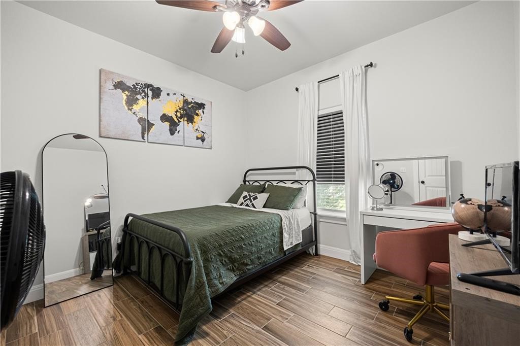 1570 Maryville Loop Beeville, TX 78102 - Photo 10 of 19 a bedroom with a bed and wooden floor