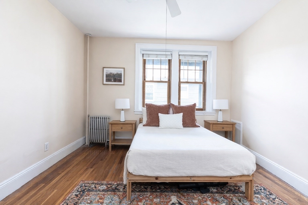 48 Strathmore Road, Unit 26 Boston, MA 02135 - Photo 11 of 15 a bedroom with a bed and wooden floor