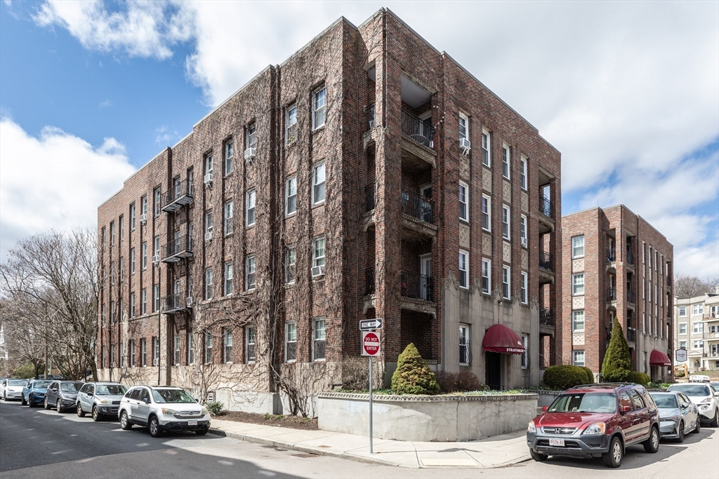 48 Strathmore Road, Unit 26 Boston, MA 02135 - Photo 15 of 15 a city street lined with buildings and cars