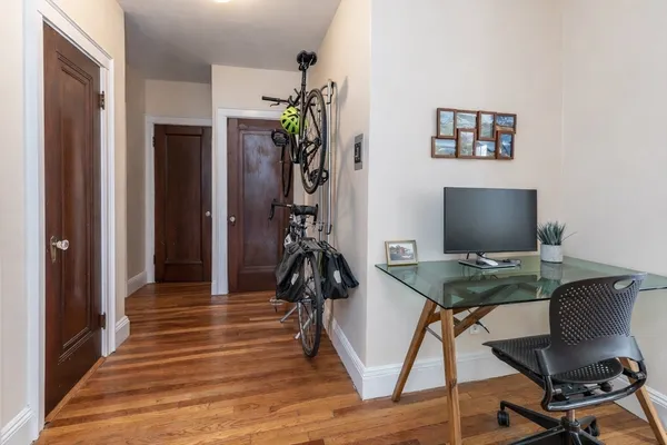 a view of a workspace with furniture and wooden floor