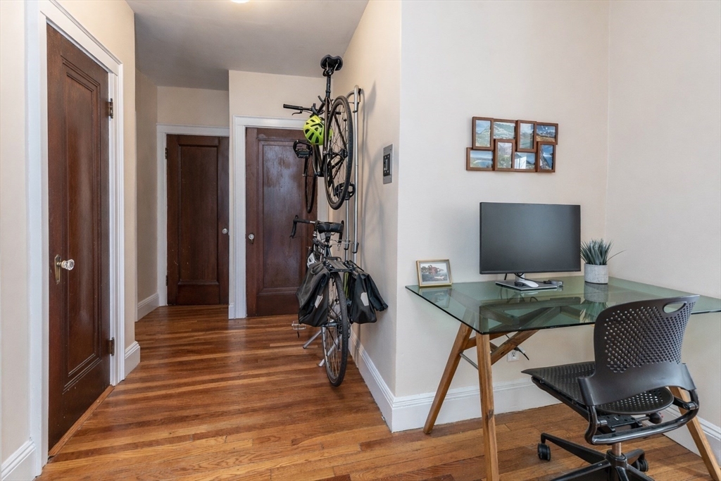 48 Strathmore Road, Unit 26 Boston, MA 02135 - Photo 7 of 15 a view of a workspace with furniture and wooden floor