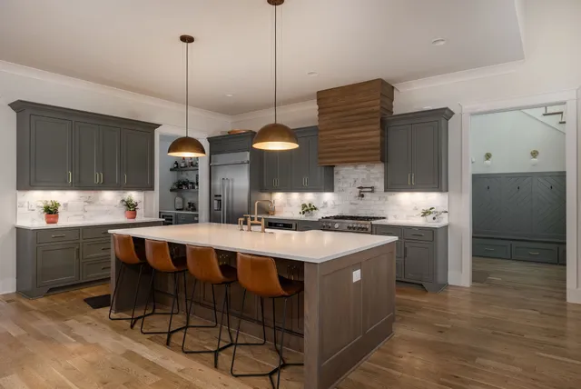 a large bed sitting in a bedroom next to a window with a dresser