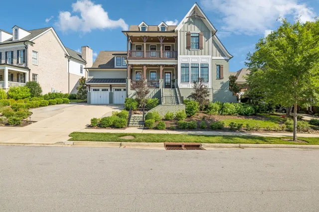 a view of a hallway with wooden floor and windows