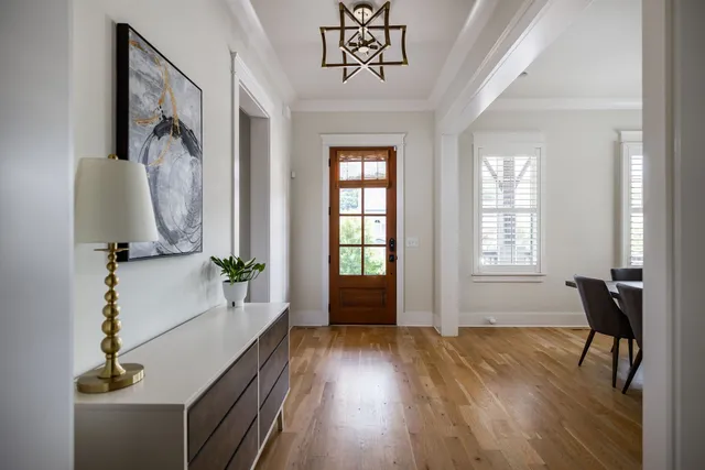 a kitchen with a stove and a wooden floor