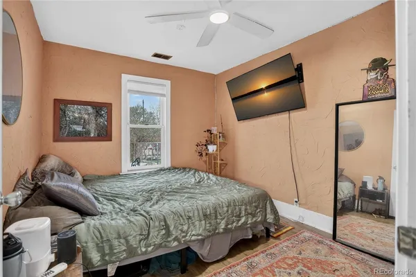 a bedroom with a bed and a mirror